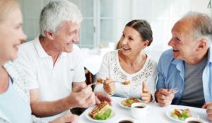 Senior with hearing loss communicating effectively over family meal